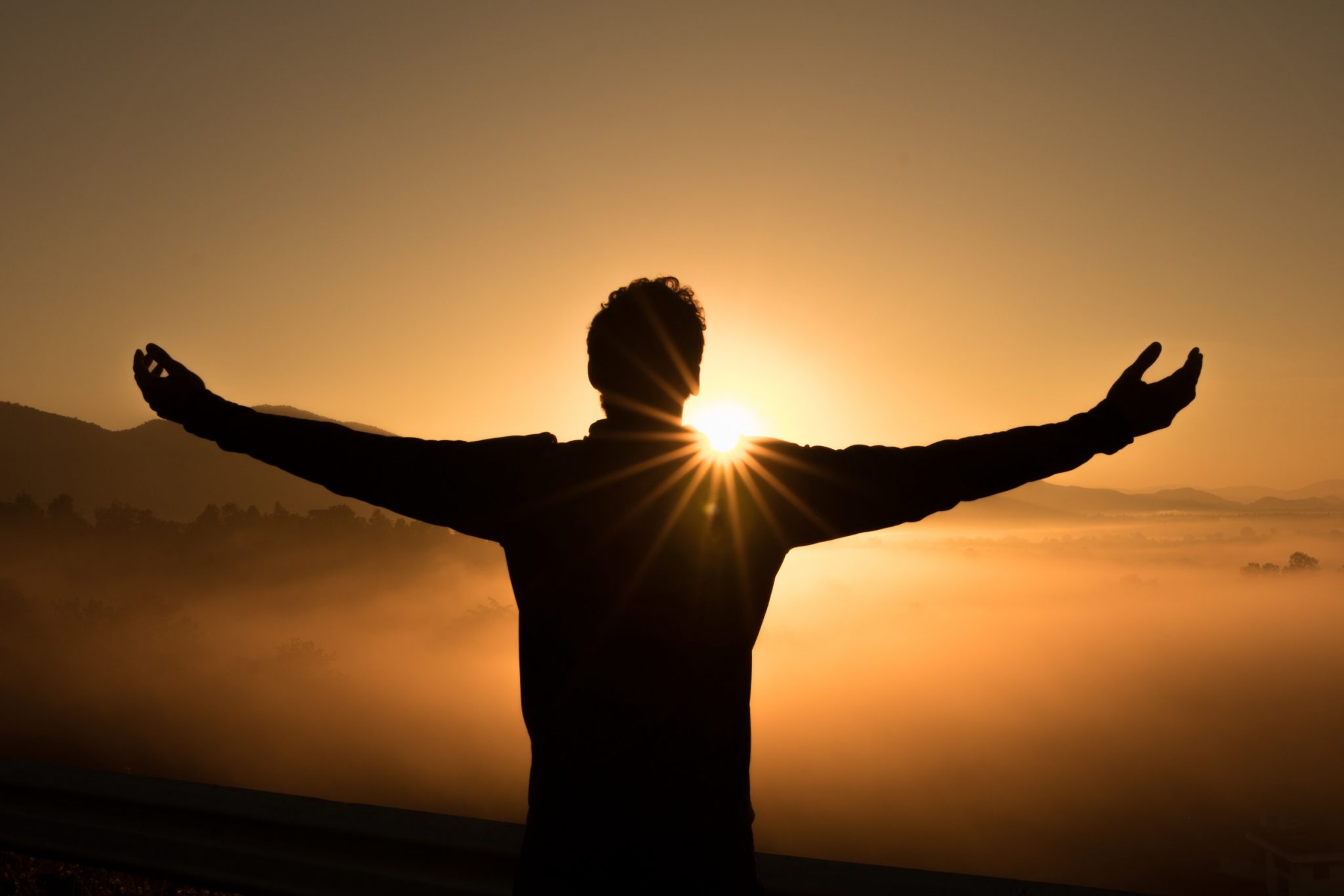A Man holding his hands up towards the sun in gratefulness #think happy #live happy #positive mindset